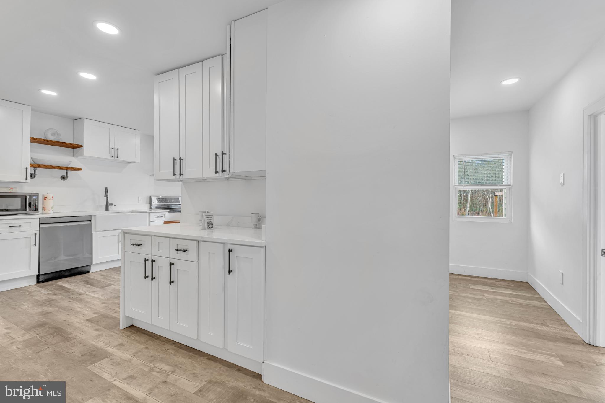 572 Zoe Road Sicklerville, NJ 08081 - Photo 23 of 40 Modern kitchen with sleek white cabinetry.