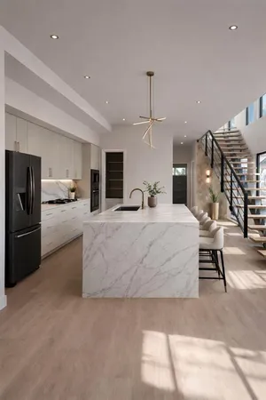 a large bedroom with kitchen island a large counter space and stainless steel appliances