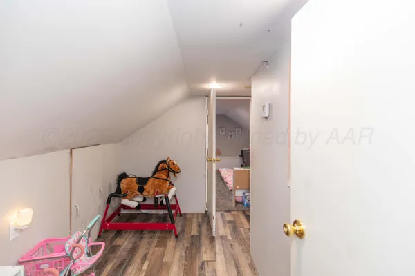 a bedroom with a bed and a mirror