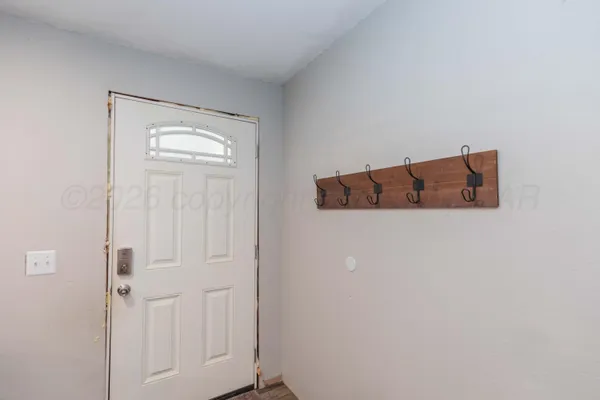a living room with furniture and white walls