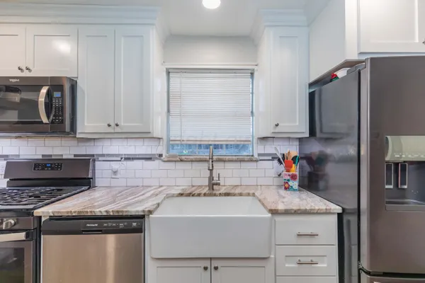 a kitchen with stainless steel appliances a stove microwave and a refrigerator