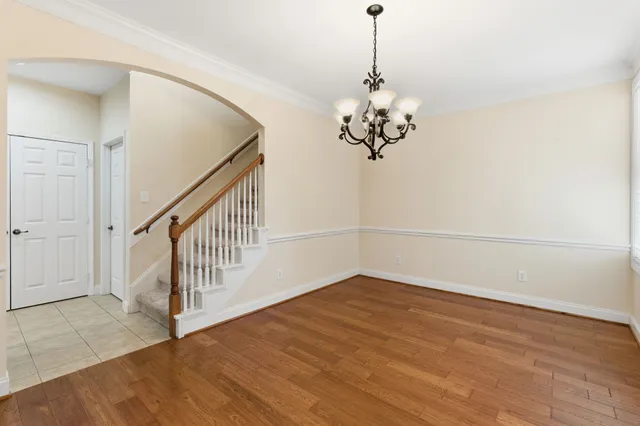 a view of a room with wooden floor and white walls