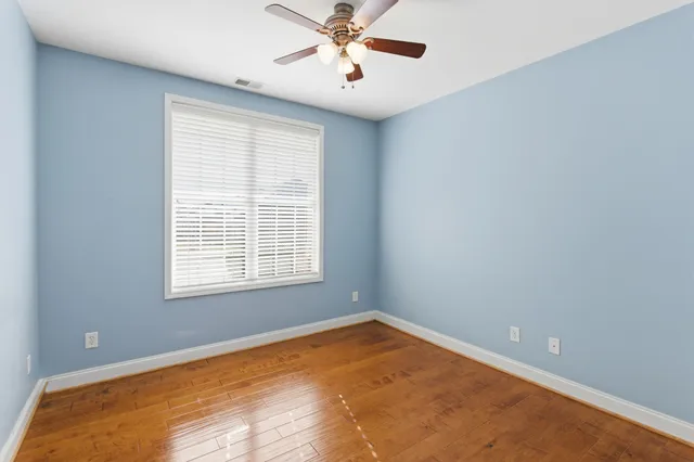 a view of empty room with ceiling fan