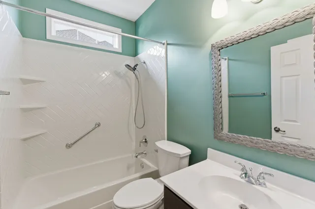 a bathroom with a toilet sink and shower