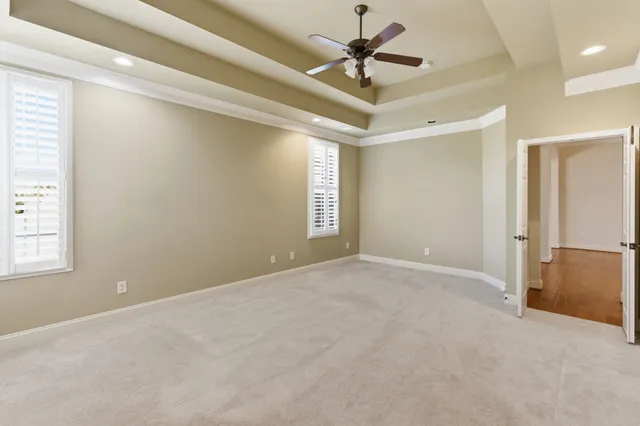 a bathroom with a tub a double vanity sink and a mirror