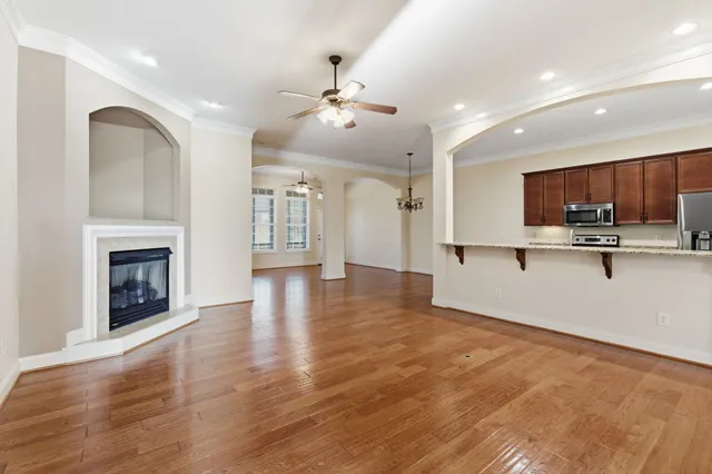 a view of kitchen with granite countertop stove top oven and refrigerator