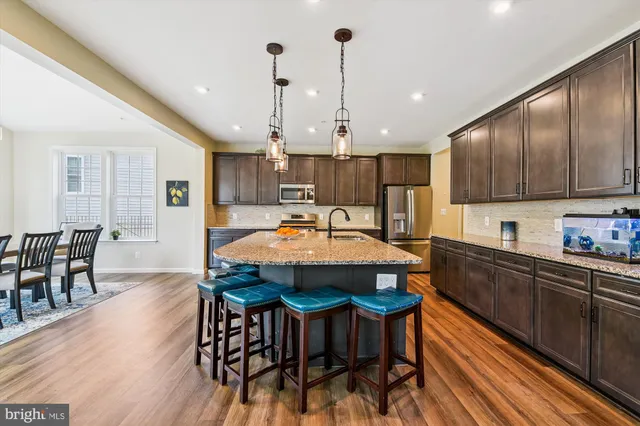 a bathroom with a double vanity sink toilet mirror and bathtub
