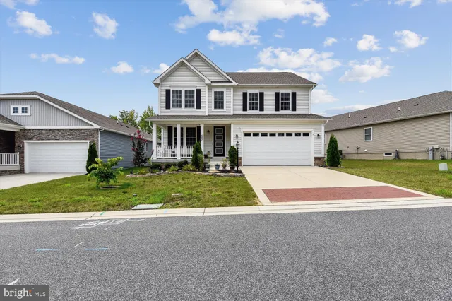 a front view of a house with plants