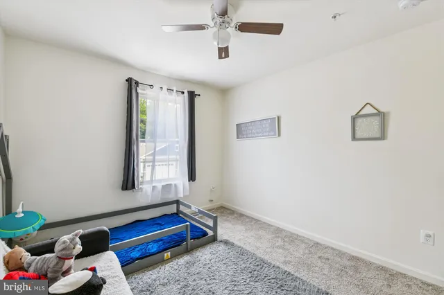 a view of a house with a big yard and a large tree