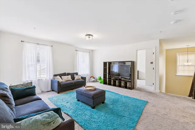 a dining room with wooden floor a chandelier a wooden table and chairs