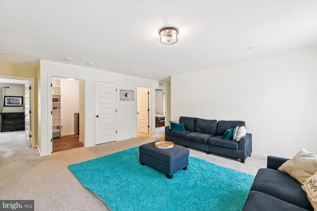 a living room with furniture and large windows