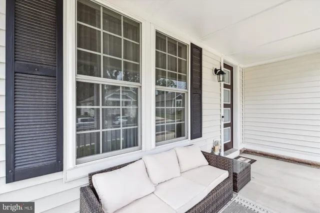a dining room with furniture a chandelier and wooden floor