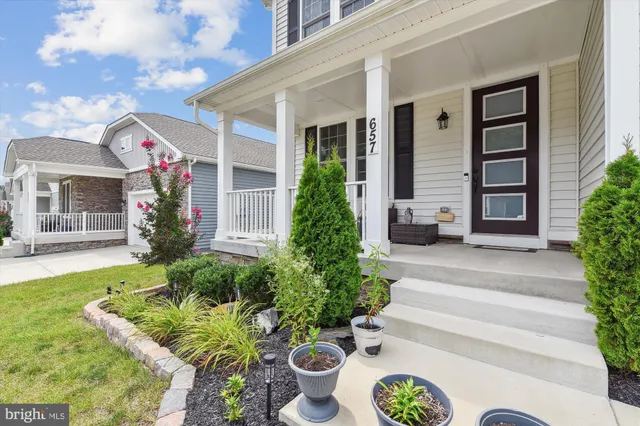 a kitchen with stainless steel appliances kitchen island granite countertop a table chairs sink and cabinets