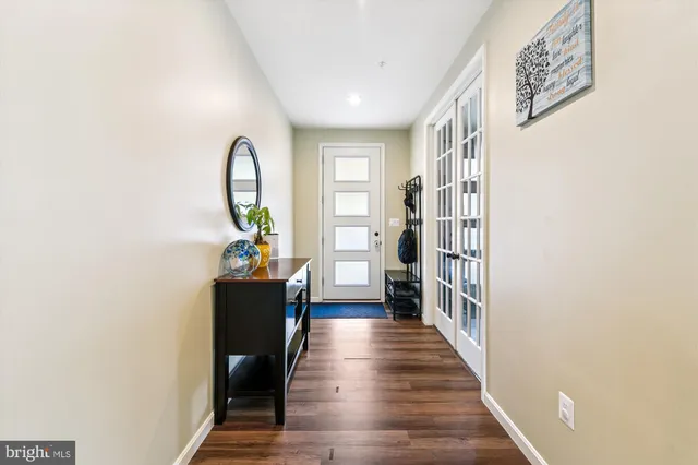 a kitchen with stainless steel appliances granite countertop a table chairs stove and refrigerator
