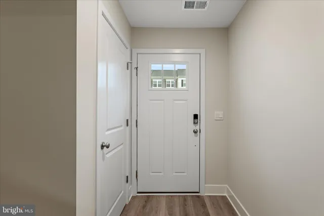a view of a hallway with wooden floor
