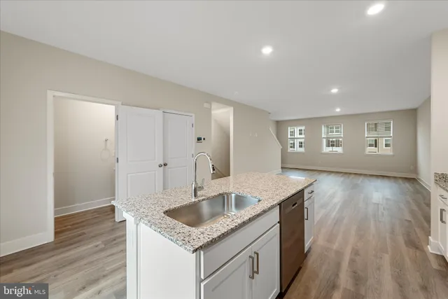 a kitchen with sink and refrigerator