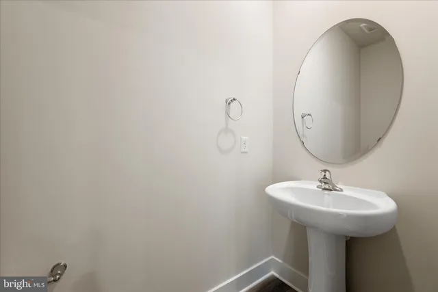 a bathroom with a sink and mirror