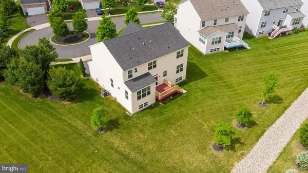 an aerial view of residential house with outdoor space and swimming pool