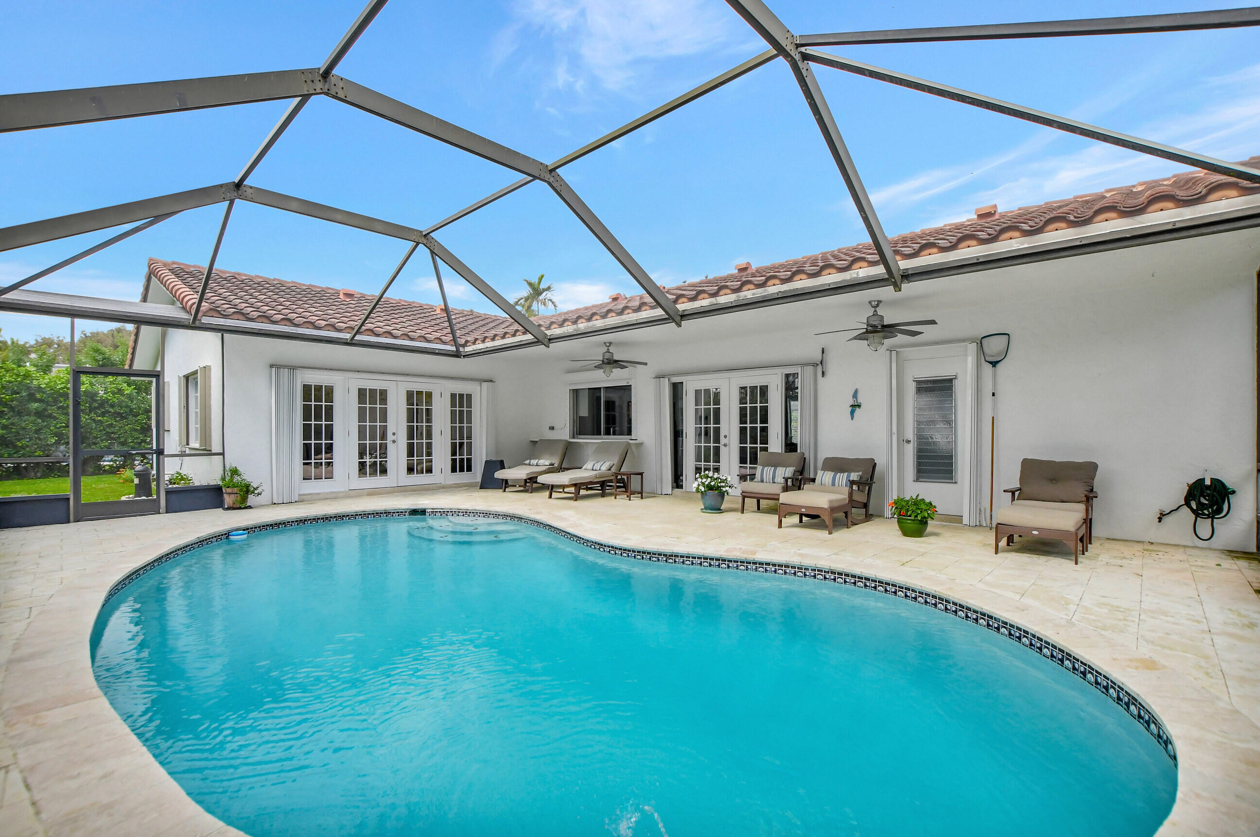 510 Silver Lane Boca Raton, FL 33432 - Photo 17 of 24 a view of a house with swimming pool and sitting area