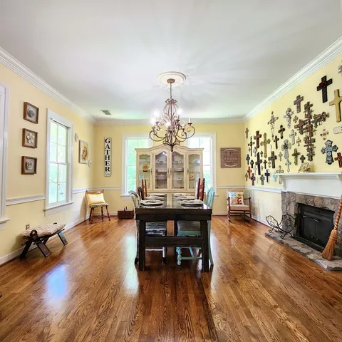 a living room with furniture dining table and a fireplace