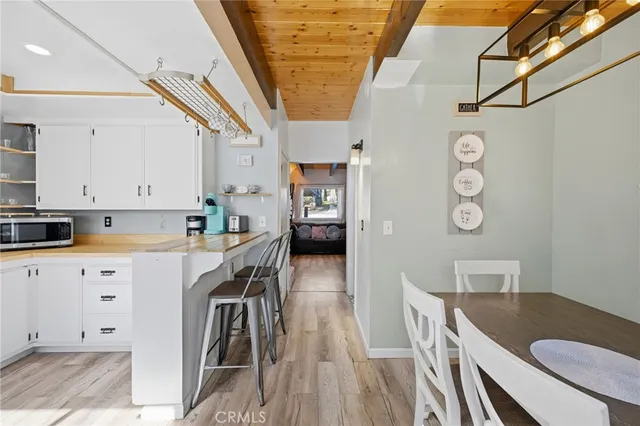 a kitchen with cabinets table and chairs