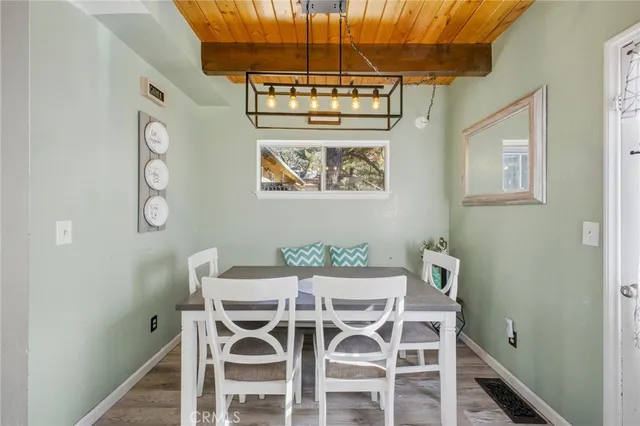 a view of a dining room with furniture and a chandelier