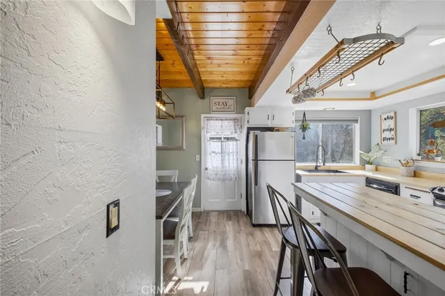 a kitchen with stainless steel appliances granite countertop a kitchen island a stove and a refrigerator