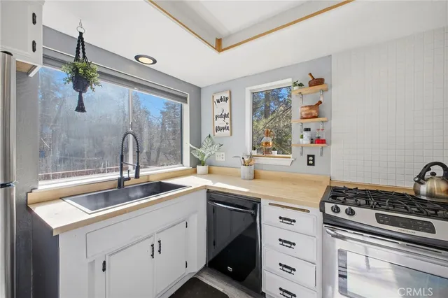 a kitchen with a sink stove and cabinets