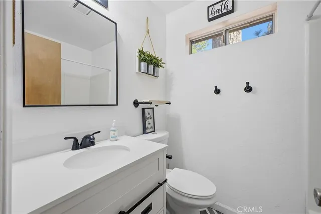a white toilet sitting next to a bathroom sink