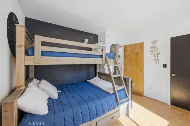 a bedroom with a bed and cabinets