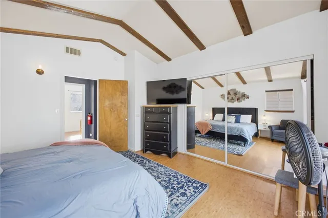 a bedroom with furniture and a flat screen tv