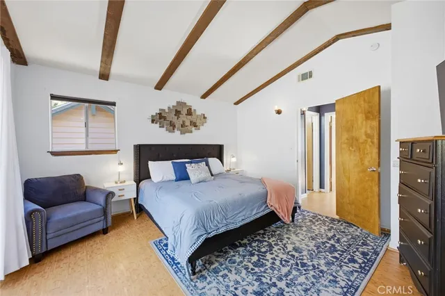 a bedroom with a bed couch and a window