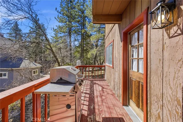 a view of a balcony with wooden floor and fence