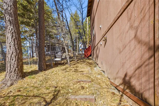 an aerial view of a house with yard and seating space