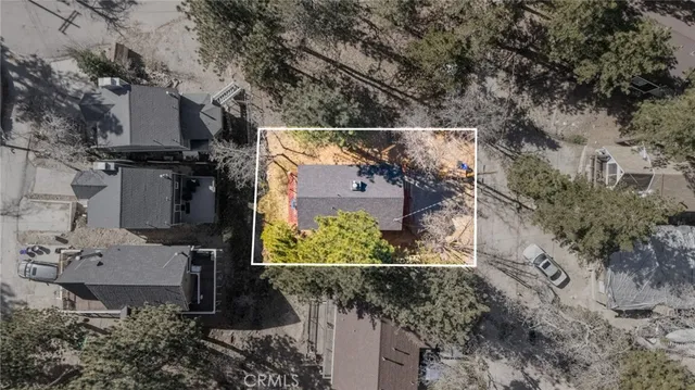 an aerial view of a house with a yard