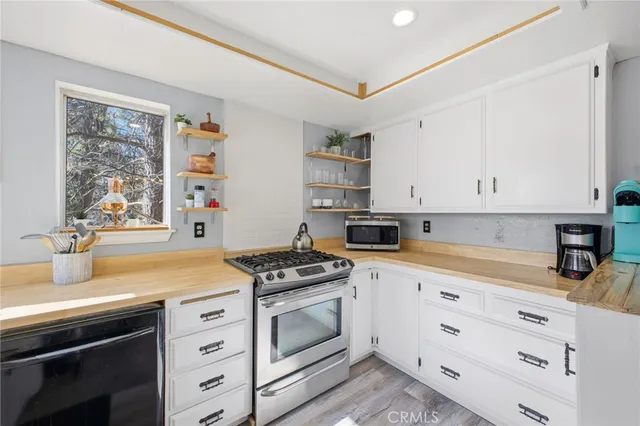 a kitchen with cabinets appliances a sink and a window