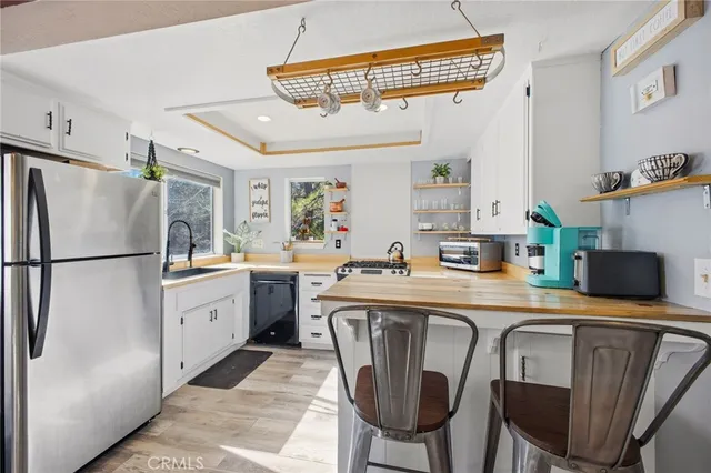 a kitchen with stainless steel appliances a stove a refrigerator and a refrigerator