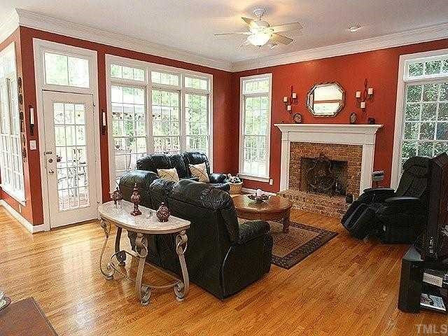 2332 Primrose Valley Court Raleigh, NC 27613 - Photo 2 of 12 Family room features windows galore, hardwoods, gas log fireplace with brick surround, crown molding, and a ceiling fan. Den/Family/Great Room