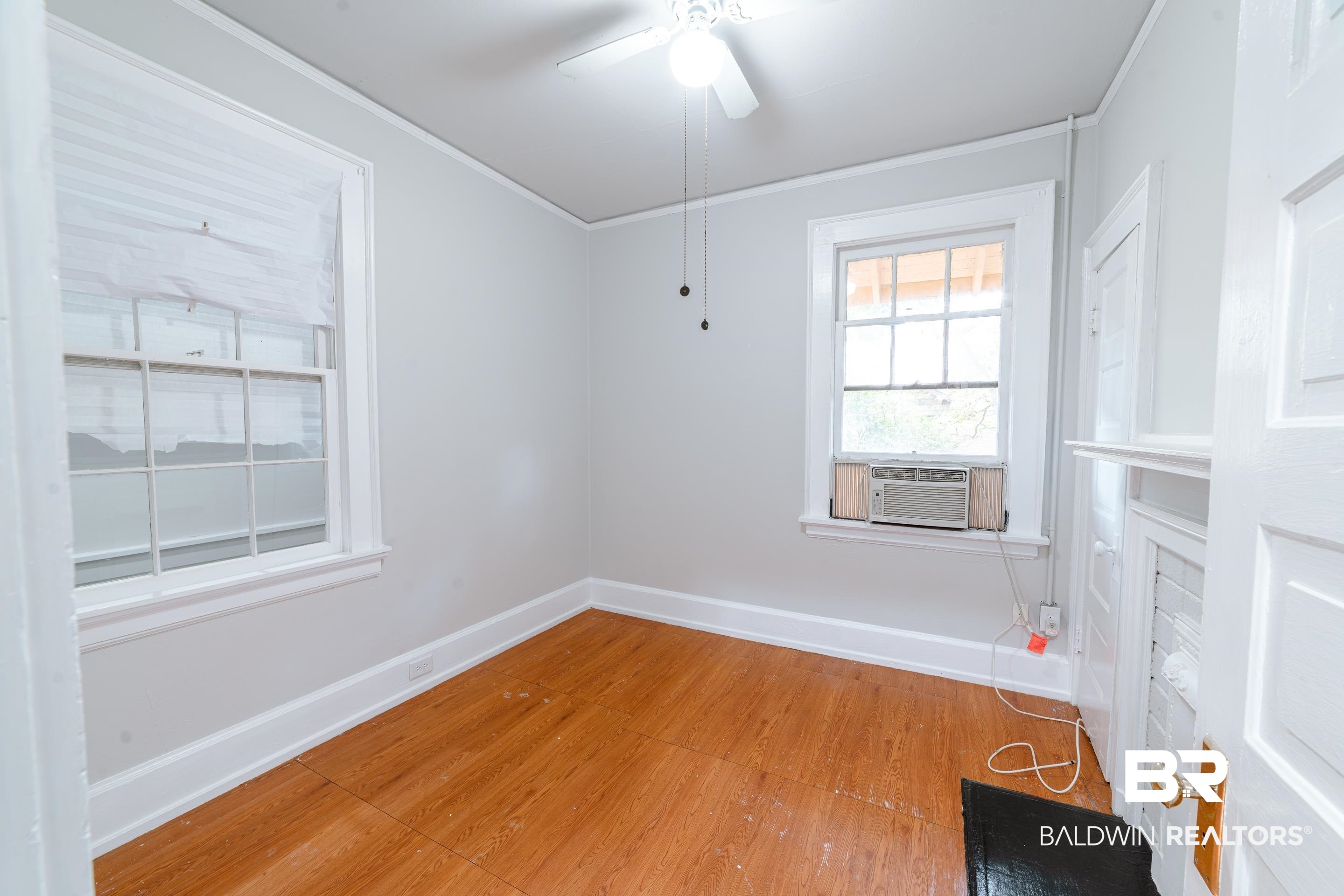 312 1st Street Mobile, AL 36611 - Photo 15 of 29 Unfurnished room with cooling unit, hardwood / wood-style floors, and ceiling fan