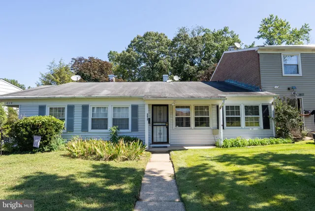 a view of a house with a yard and potted plants