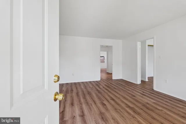 a view of an empty room and wooden floor