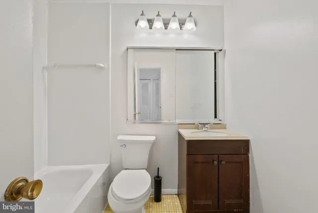 a white toilet sitting next to a bathroom sink