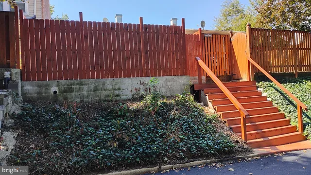 a view of a house with wooden fence