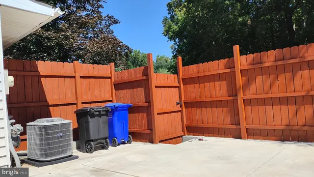 a view of a house with a wooden fence
