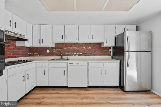 a white refrigerator freezer sitting in a kitchen