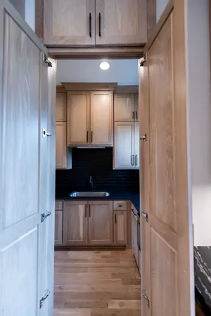 a view of an empty room with a kitchen
