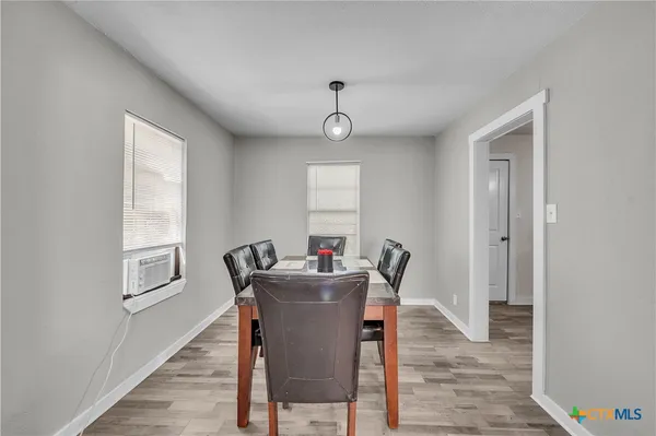 a dining room with furniture and window