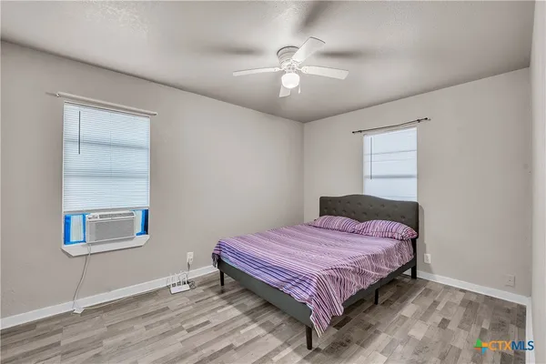 a bedroom with a bed and a chandelier