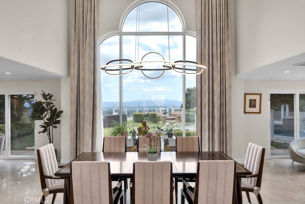 11677 Seminole Circle Porter Ranch, CA 91326 - Photo 19 of 69 a view of a dining room with furniture a chandelier and wooden floor