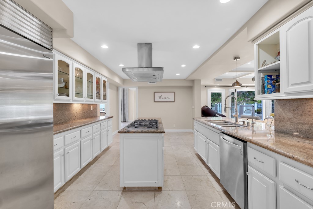 11677 Seminole Circle Porter Ranch, CA 91326 - Photo 26 of 69 a kitchen with stainless steel appliances granite countertop a sink and cabinets